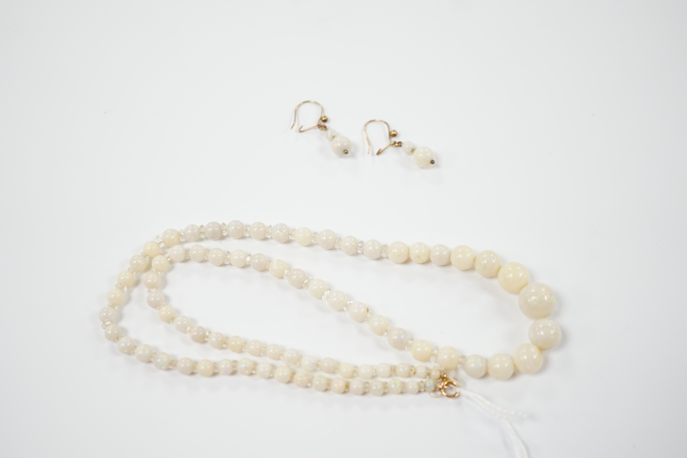 A single strand graduated white opal bead necklace, with 9ct clasp, 50cm and a pair of similar drop earrings.